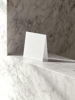Elegant vertical business card mockup on marble surface for professional branding design photo