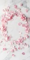 Elegant flat lay with scattered sakura petals on marble surface for spring design photo