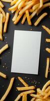 Minimalistic food art with golden fries on black background for creative design concepts photo