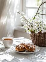 Cozy and inviting Easter morning with fresh flowers and hot cross buns photo