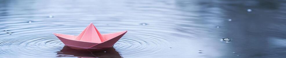 Serenity of a paper boat in a pastel toned puddle setting for tranquil design themes photo