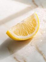 Fresh lemon wedge on white marble surface with natural light photo