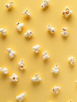 Minimalistic popcorn pattern on solid light yellow background for creative design photo