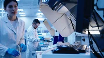 Group of Scientists use lab equipment for an experiment, working with test tubes and samples. Scientific research and experiments using cutting-edge technology in the laboratory video