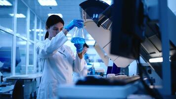 Scientists use lab equipment for an experiment, working with test tubes and samples. Scientific research and experiments using cutting-edge technology in the laboratory video