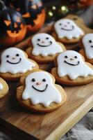 Halloween cookies with white frosting and smiling faces photo