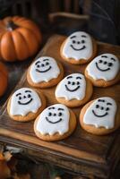 Halloween cookies with white frosting and faces photo