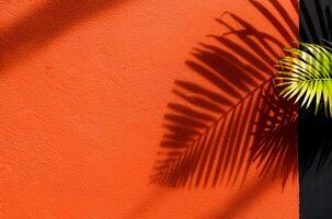 Orange background with Tropical palm leaf shadow, light overlay on concrete wall texture for Product display.Natural leave silhouette on architecture exterior aesthetic. Creative boho summer vibes photo