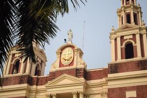 A large church with a clock on top of it photo