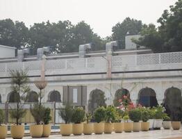 A large building with many potted plants in front of it photo