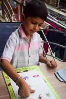 A young boy is playing with a piece of paper photo