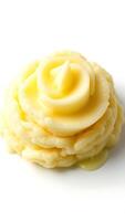 Delicate closeup of creamy butter shaped like a rose on a white plate photo