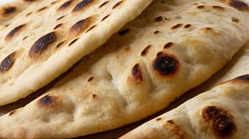 Closeup view of freshly baked naan bread highlighting its texture and flavor photo