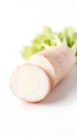 Closeup view of sliced radish with green leaves on a neutral background photo