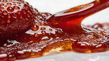 Closeup of a dollop of fresh strawberry preserves showing textures and shine photo