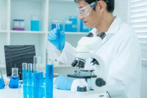 analyze biochemical samples in advanced scientific laboratory. Medical professional use microscope look microbiological developmental of viral. Biotechnology research in science lab photo