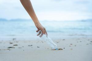 Save water. Volunteer pick up trash garbage at the beach and plastic bottles are difficult decompose prevent harm aquatic life. Earth, Environment, Greening planet photo
