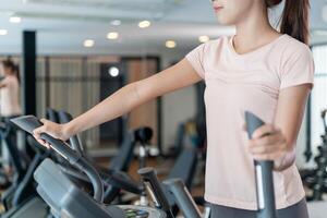 woman use Elliptical. exercisers and are checking how to exercise properly. correct exercise. diet, body shape, healthy, strong, care, gym, fitness, vacation photo