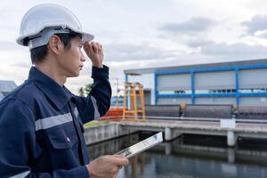 maintenance and inspector, Maintenance engineers are using tablet to checking results of inspection of buildings and structures. Irrigation engineers are exploring sluice systems photo