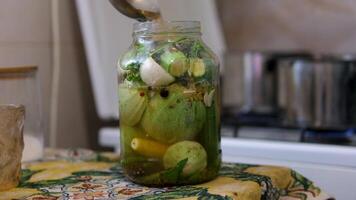 process of rolling up zucchini in a jar. Step by step. zucchini on the table, storage of zucchini in jars close the lids on canned jars with a key, a female housewife closes jars of zucchini video