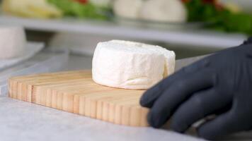 Camembert, Cooking process, Step by step worker at a craft cheese factory turns over cheese blanks production soft cheese video
