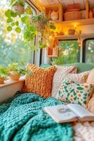 A bed with pillows and books on the window sill photo