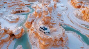 An aerial view of a car driving through a canyon photo