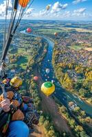 A view of hot air balloons flying over a river photo