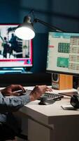 Vertical Operating from home setup, male freelancer evaluating monetary data and searching international capital funds sources to help expand the business. Fiscal analyst validates budget balance. Camera A. video