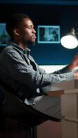 Vertical Researcher exhausted after working overtime to finish tasks on schedule. African American under pressure with stress from the leadership team, overcome major difficulties remotely. Camera A. video