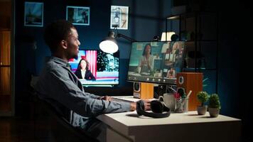 African american remote worker attending a web meeting call in a living room. Smiling black man engages in virtual communication to discuss about executive matters from home office. Camera A. video