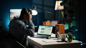 African american freelancer solving daily tasks with music on headset, listening to groovy songs and dancing at home office. Young adult enjoys multitasking with audio, self employed. Camera B. video