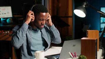 African American guy waving at a call connection with workmates, working remotely from his apartment and participating in executive meetings. Virtual communication. Camera B. video