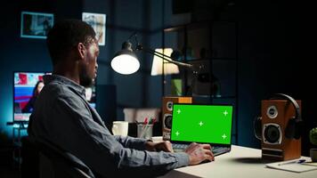 Self employed person checking financial graphs on chroma key screen, researching and sharing insight. Remote worker comparing business graphic economic figures, creating a strategy. Camera A. video