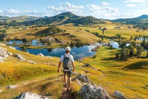Man hiking in the mountains photo