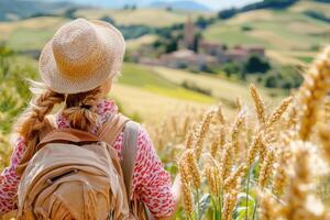 A girl with a backpack in a wheat field photo
