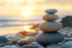 Balance and harmony concept. Stack of smooth white stones on the seashore at sunset. photo