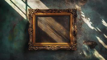 An ornate, antique picture frame hangs against a textured wall, casting intricate shadows in the soft sunlight photo