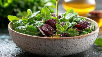 A bowl of salad with greens and olive oil photo