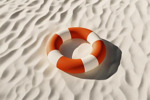 Bright orange and white lifebuoy resting on textured sand with sunlight casting a shadow photo