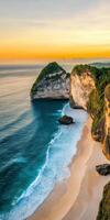 Scenic tropical beach with cliffs and golden sunset over turquoise water for mobile wallpaper photo