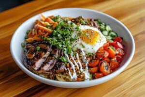 Gourmet bowl with grilled steak, sunny-side egg, fresh vegetables, and drizzled dressing photo