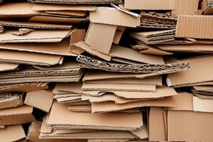 Pile of stacked cardboard sheets and boxes in a recycling or packaging context photo