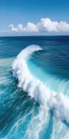 Aerial View of a Powerful Ocean Wave Crashing into the Deep Blue Sea photo