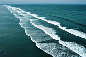Aerial view of perfectly aligned ocean waves flowing towards shore photo