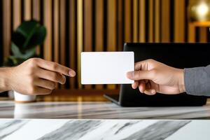 Two Hands Exchanging Blank White Business Card, Professional Office Setting, Corporate Identity photo