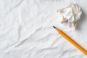 Yellow Pencil and Crumpled Paper on White Background, Minimalist Writing Concept photo