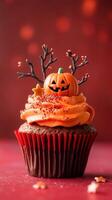 Delicious Halloween Cupcake with Pumpkin Topper and Red Sparkling Sprinkles photo
