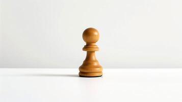 A wooden chess piece on a white surface photo