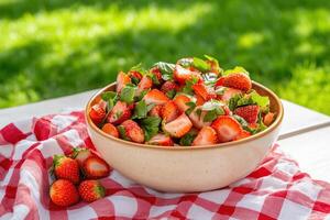 A bowl of strawberries on a table photo